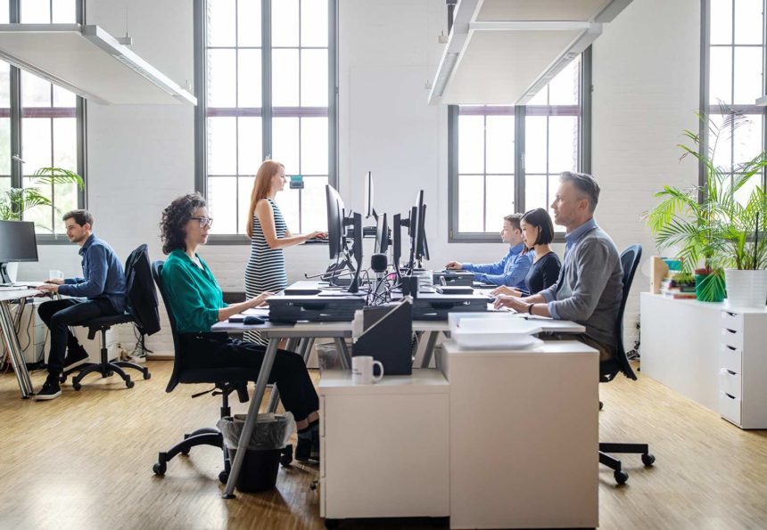 Colleagues working at their desks in modern office environment