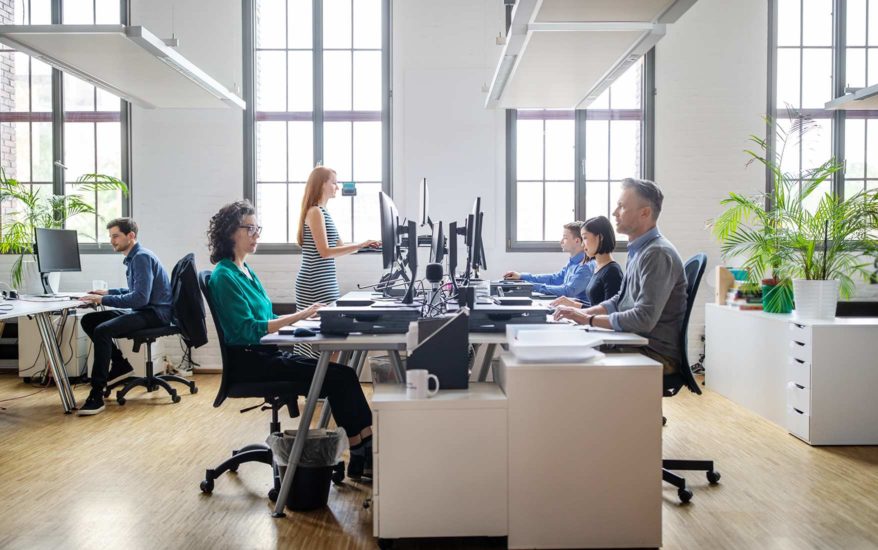 Colleagues working at their desks in modern office environment